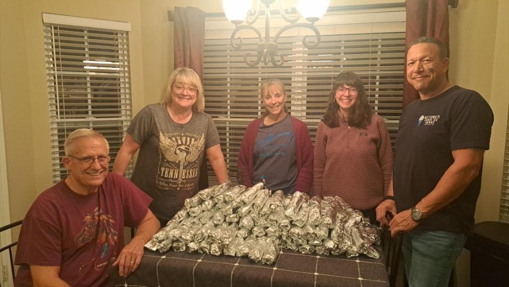 Serve Mercy volunteers with burritos ready for outreach